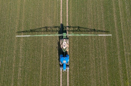 Field being fertilised by machine